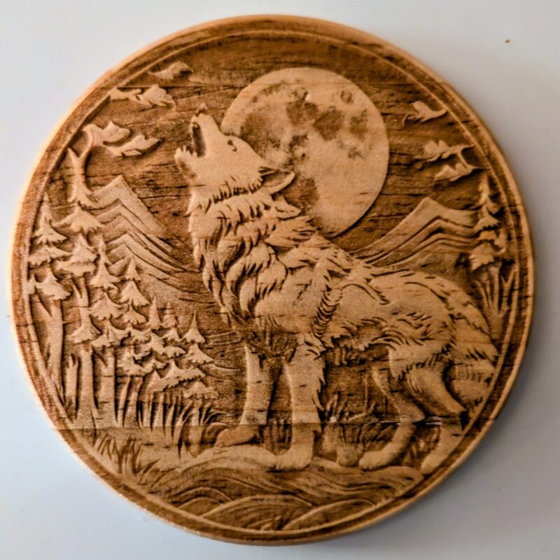 wood coaster with a wolf engraved on it