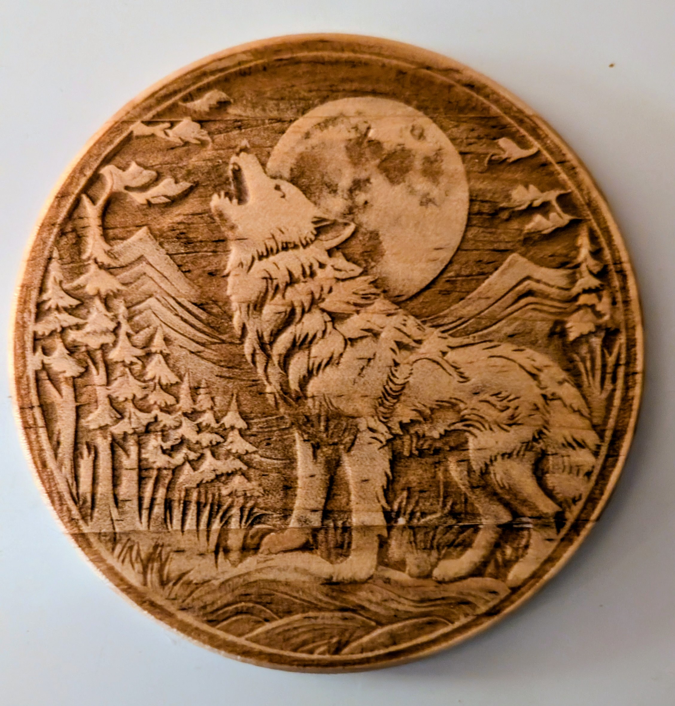wood coaster with a wolf engraved on it